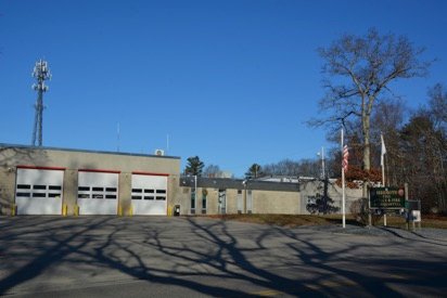 A Rehoboth Fire Department firehouse: a low tan and gray station with three apparatus bays.
